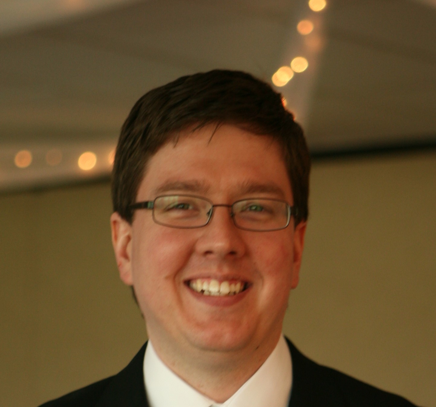 Charles Vanek smiling and wearing glasses